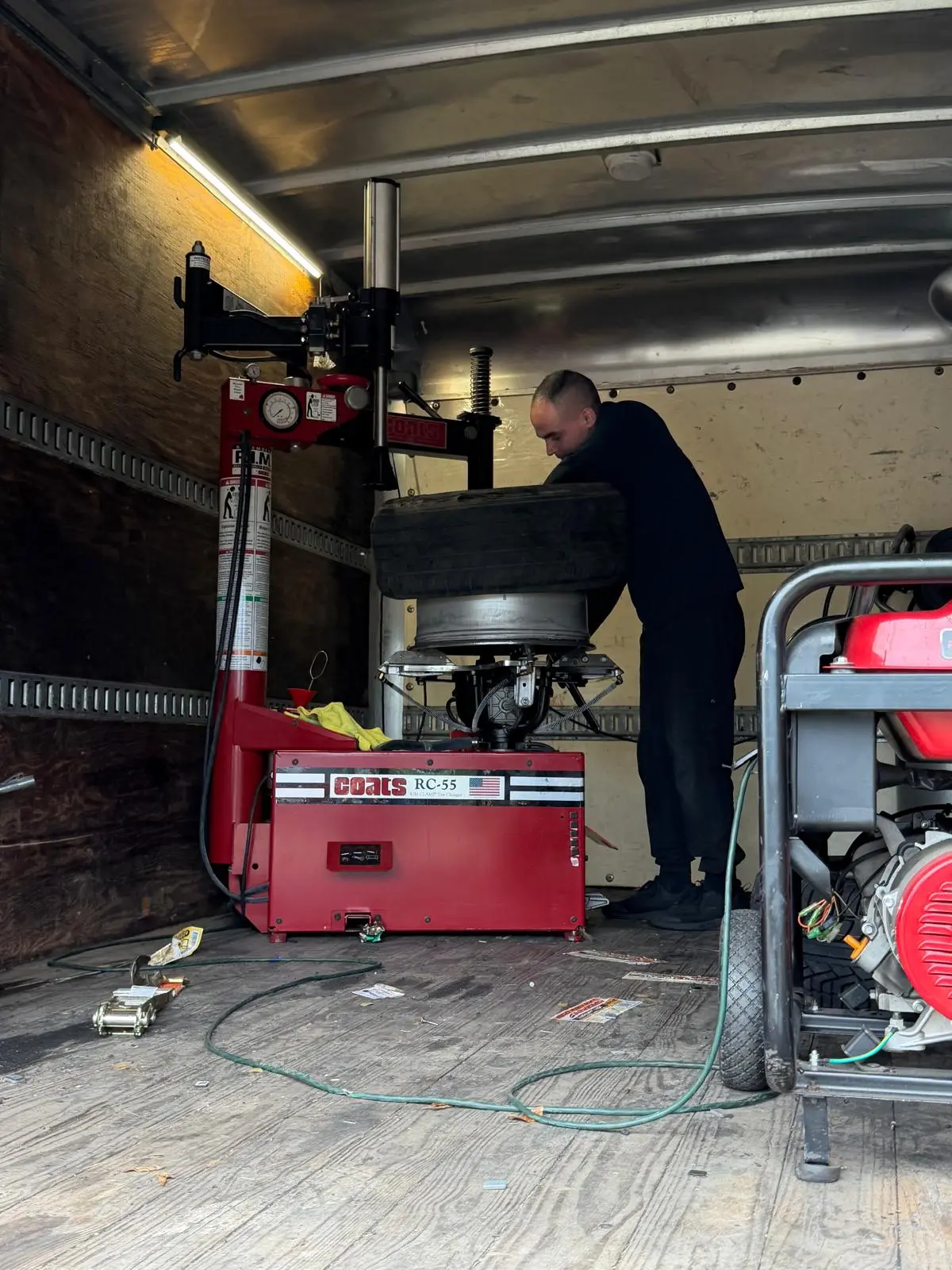 Inside the mobile van — a full tire changer rides along