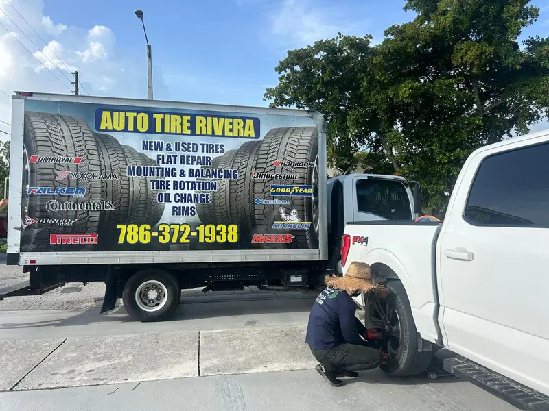 The mobile van on-site changing a pickup's tire